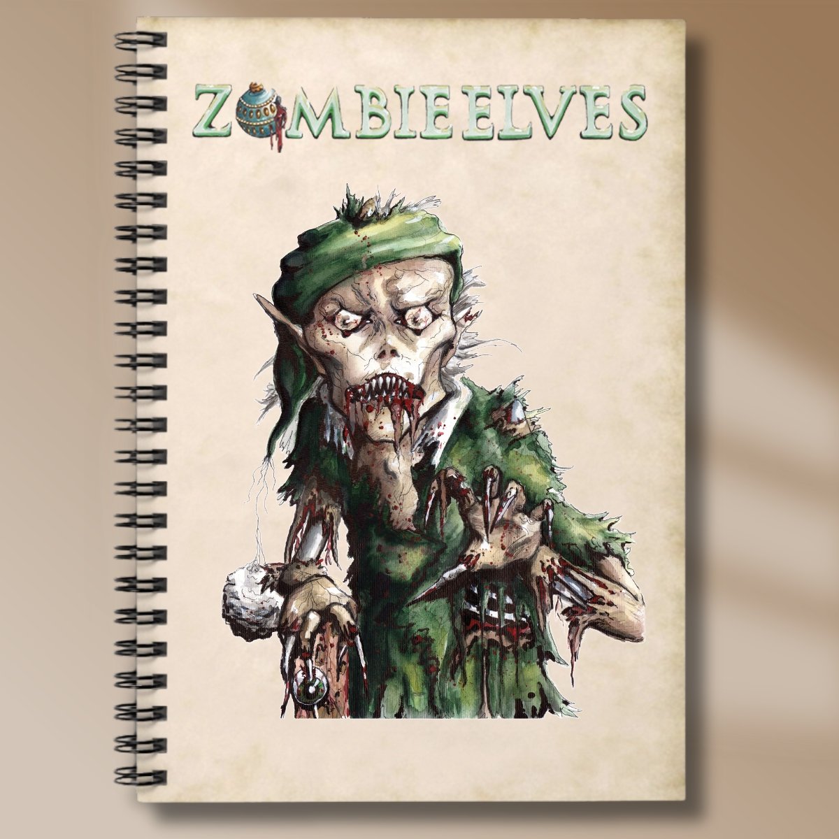 Creepy zombie elf with an eyeball stabbed in its fingernails on a hand-painted notebook